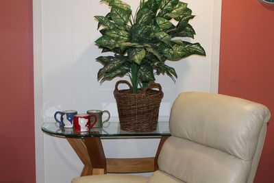 Three handcrafted ceramic coffee mugs on a side table