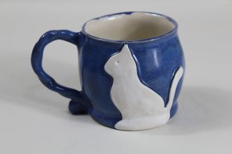 Blue stoneware coffee mug with white cat decor