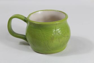 Green stoneware coffee mug with belly