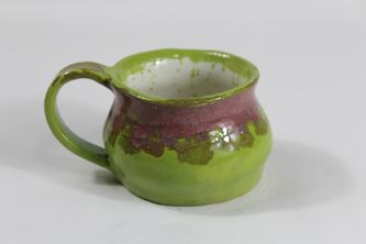 Green coffee mug with belly and a purple rim